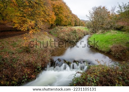 Long exposure of the waterfall at Robbers Bridge in Exmoor National Park in autumn