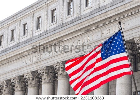 USA national flag waving in the wind in front of United States Court House in New York Royalty-Free Stock Photo #2231108363