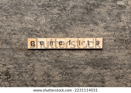 Benefits word written on wood block. Benefits text on cement table for your desing, Top view concept.
