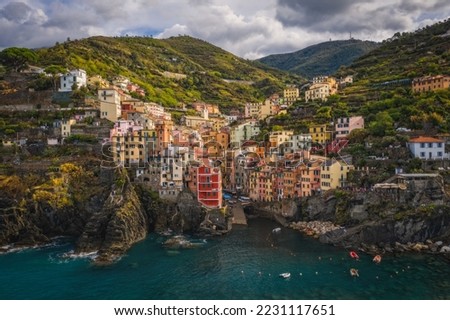 Riomaggiore, Italy - September 2022: The colorful fishing village of Riomaggiore, Italy, one of the five Cinque Terre Villages along the Ligurian Sea. Aerial drone shot