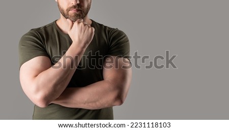 cropped view of muscular man wear tshirt. muscular man isolated on grey background with copy space