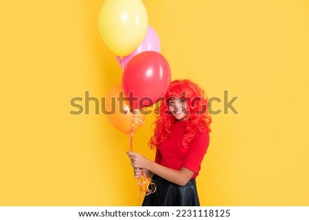 smiling kid with party balloon on yellow background