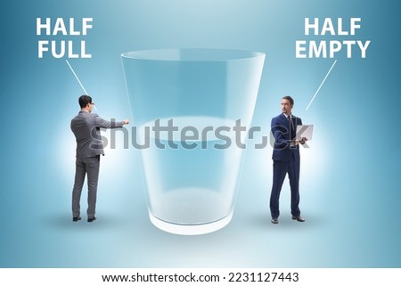 Businessman in half empty half full glass concept Royalty-Free Stock Photo #2231127443