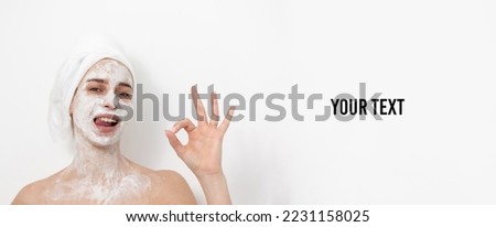 Beautiful woman with facial mask on white background. Shows okay gesture. Skin care concept. Copy space
