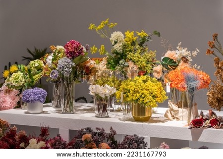Beautiful showcase of flower shop with large assortment of artificial flowers.