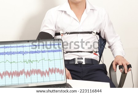 A man passes a lie detector test Royalty-Free Stock Photo #223116844