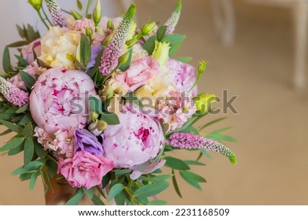 Rich bunch of pink peonies and lilac eustoma roses flowers, green leaf . Fresh spring bouquet. Holodays, gift.Arrangement of Beautiful blossoming flowers.wedding bouquet.copy space Royalty-Free Stock Photo #2231168509
