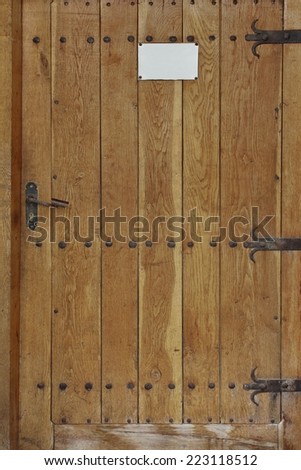 Old Wooden Door with forging nails and handle. Background and Texture for text or image.
