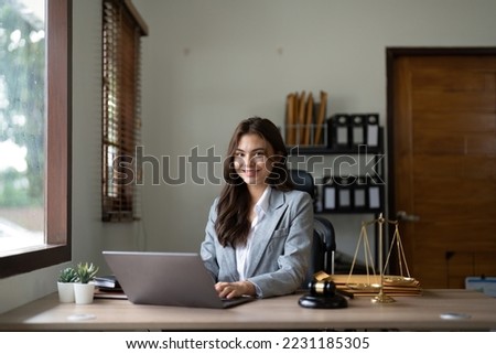 justice and law concept.Male judge in a courtroom on wooden table and Counselor or Portrait asian lawyer working with lsptop in office. Legal law, advice and justice concept Royalty-Free Stock Photo #2231185305