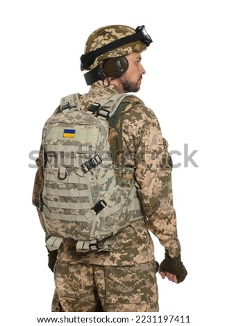 Soldier in Ukrainian military uniform with tactical goggles and backpack on white background