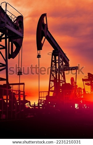 Prairie Oil Pump Jacks. One pump jack producing oil. Crude oil is a major economic driver. Abstract image