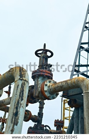 Valve pipes, turn off on gas pump vent. Close-Up Of Valve On Pipeline. Oil Or Gas Transportation With Gas Or Pipe Line Valves On Soil And Sunrise Background.