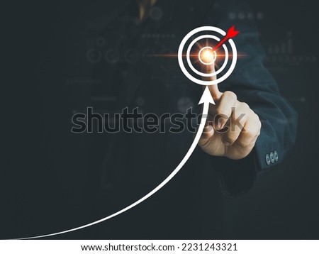 Businessman pointing to business success strategies on goals business growth achieving the goals that have been set Leading the organization to grow by leaps and bounds