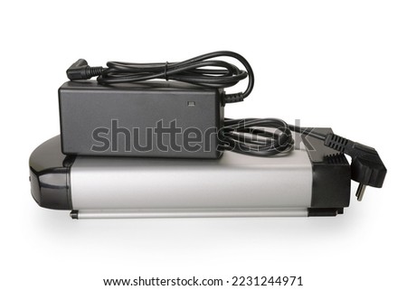 Silver and black li-ion battery for e-bike and charger set. Isolated on white, clipping path included