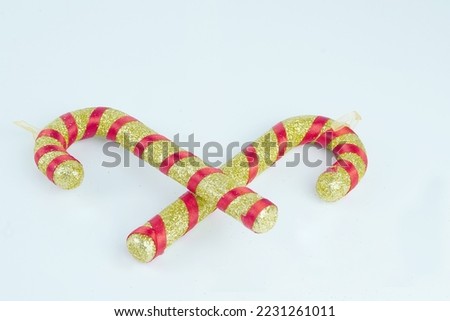 Gold and red candy cans with glitter on white background isolated with selected focus