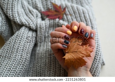 Women's hands with colorful pattern on the nails. Top view. Place for text.