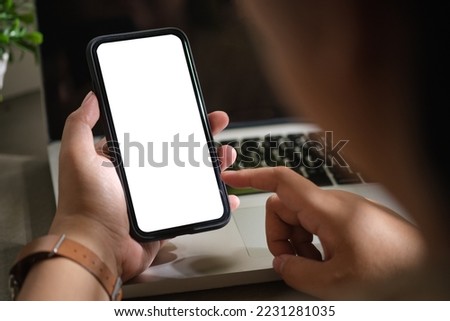Woman using mobile phone at her working desk. Close up view, Blank screen for your advertise design.
