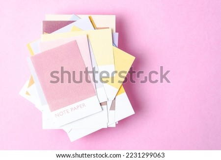 Colorful blank sticky note papers on pink colour background for your text or message.