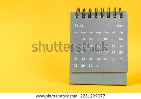 May 2023 desk calendar for 2023 year on yellow color background. Royalty-Free Stock Photo #2231299077