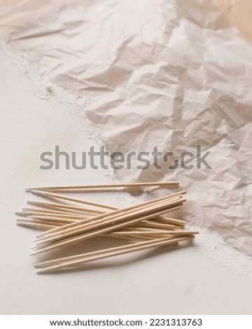 wooden sticks on a beige and white neutral background