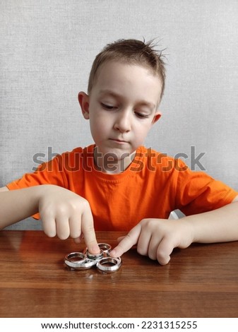 spinner helps children with ADHD, neurodivergent children, learning difficulties with ADHD, neuropsychology Royalty-Free Stock Photo #2231315255