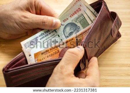 Hand takes out money from wallet, India Banknotes, Economic concept, rising prices, value of Indian rupee