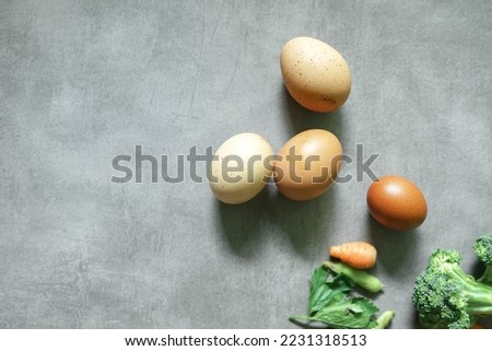 Fresh eggs are suitable for advertising on a concrete background