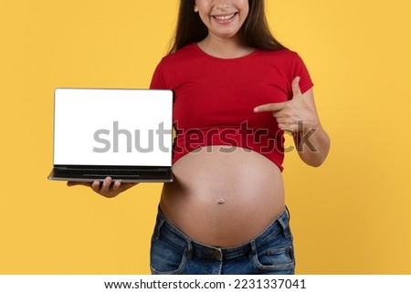 Cool Website. Smiling Pregnant Woman Pointing At Laptop With Blank White Screen, Cropped Shot Of Happy Young Expectant Lady Demonstrating Free Copy Space For Online Offer Design, Mockup