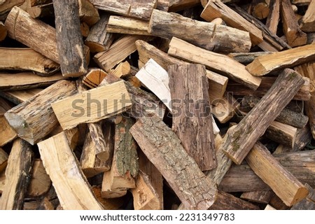 Lots of chopped oak firewood. Natural background. Harvesting for the winter, heating season.