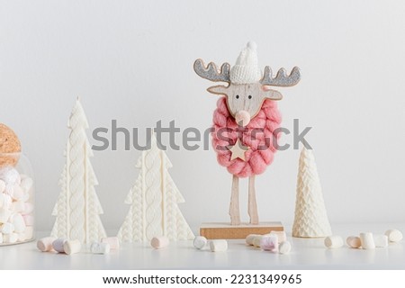 Christmas background with candle trees, moose and colorful marshmallows. White background. New year decoration concept.