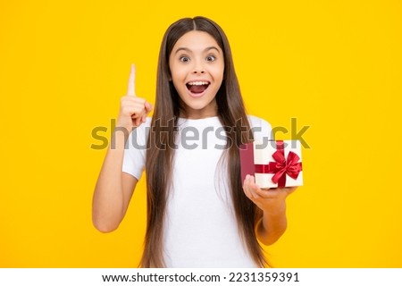 Teenager child with gift box. Present for holidays. Happy birthday, Valentines day, New Year or Christmas. Kid hold present box. Excited teenager, glad amazed and overjoyed emotions.