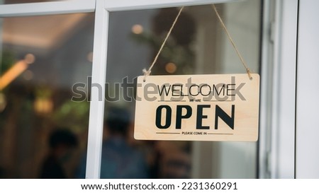 Open sign board through the door glass.