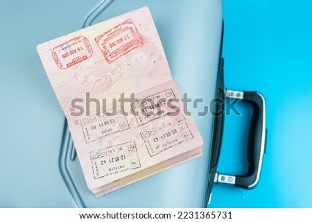 The traveler's suitcase is a passport with money and credit cards on a blue background. The concept of travel and vacation.