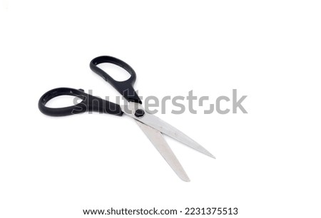 Used scissors with black handle, isolated on white background with copy space.