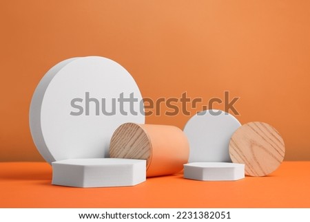 Scene for product presentation. Podiums of different geometric shapes on orange background