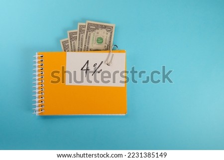 note in a sketchbook with the text 4%. 4 percent rule concept or total amount retiree should withdraw from retirement savings to establish steady safe income. Royalty-Free Stock Photo #2231385149