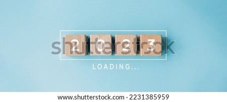 2023 New Year Loading. Loading bar with wooden blocks 2023 on blue background. Start new year 2023 with goal plan, goal concept, action plan, strategy, new year business vision. Royalty-Free Stock Photo #2231385959