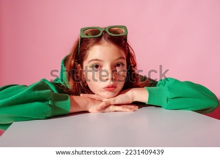 Beautiful freckled redhead girl wearing trendy green hoodie, posing against pink background. Close up studio portrait. Copy, empty space for text
 Royalty-Free Stock Photo #2231409439