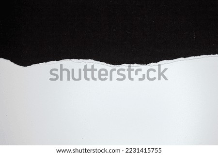 Ripped black paper on white background. Torn paper with copy space.