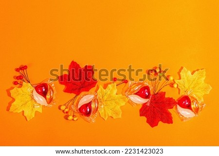 Machine washing concept. Capsules with detergent and autumn decor. Laundry pods, traditional fall style. Eco friendly clothes washing. Orange background, banner format