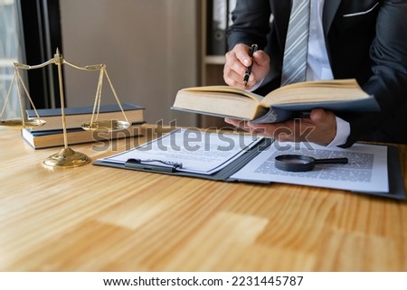 Attorney reading law code, studying constitution to protect human rights closeup, Male lawyer or judge working with Law books, gavel	

