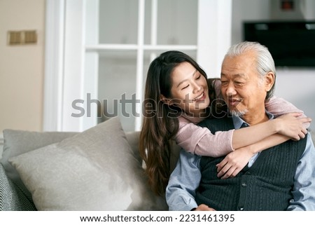 asian senior father and adult daughter sitting on couch in living room at home  enjoying a pleasant conversation Royalty-Free Stock Photo #2231461395
