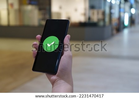 Hand holding mobile smart phone with verification. validation process. cyber security safe data protection. Royalty-Free Stock Photo #2231470417
