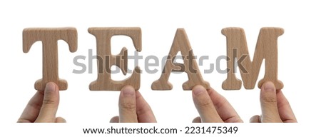 Hands holding wooden word team