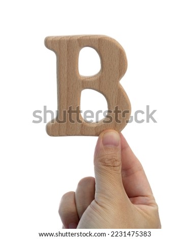 Hand holding wooden letter B