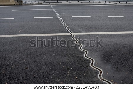 expansion joint or movement joint while safely absorbing thermal expansion and contraction of building materials and vibrations to allow movement due to ground settlement or seismic activity.  Royalty-Free Stock Photo #2231491483