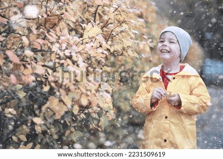 Kids walk in the park with first snow Royalty-Free Stock Photo #2231509619