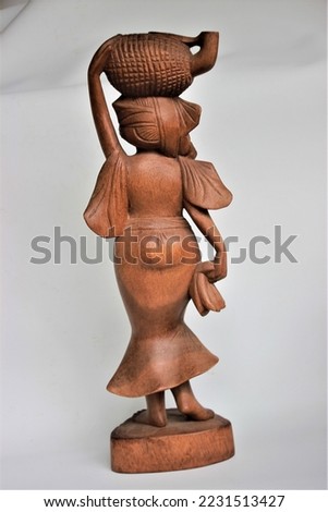 Balinese Girl Wood Carving, Wooden Statue, Wood Sculpture, Hand Made, Art from Bali Indonesia Royalty-Free Stock Photo #2231513427