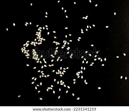 Sesame seeds isolated on black background top view Royalty-Free Stock Photo #2231541219
