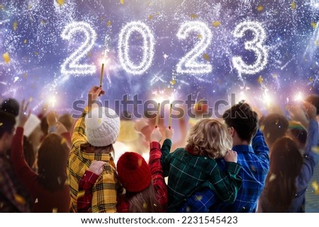 Happy new year. Family watching fireworks. Parents and kids celebrate new 2023 year. Winter holiday party. Outdoor fun. Children, mother and father with sparkler watch firework show. Royalty-Free Stock Photo #2231545423
